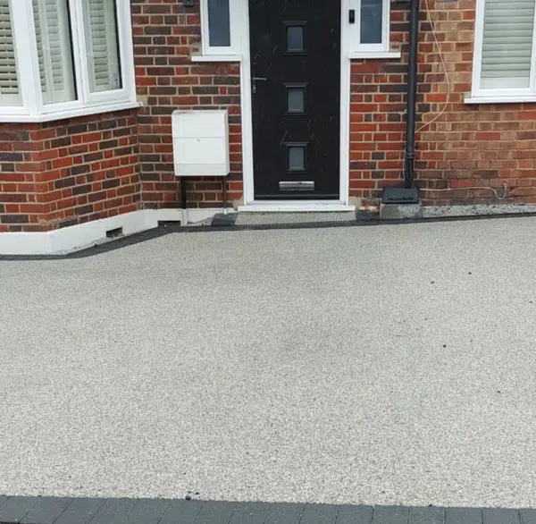 Light coloured resin surface outside a brick house