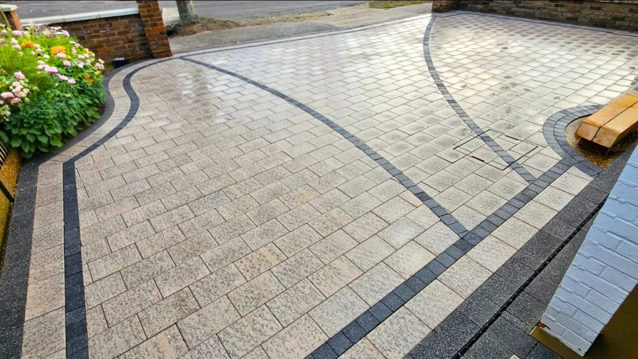 Completed grey block driveway with sweeping charcoal borders
